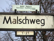 Stra�enschild mit Namenserl�uterung und Hausnummernhinweis